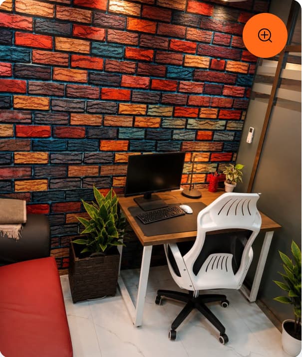A workstation against a colourful brick feature wall