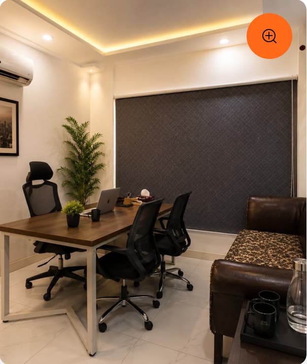 A meeting room with a wooden table and ergonomic chairs