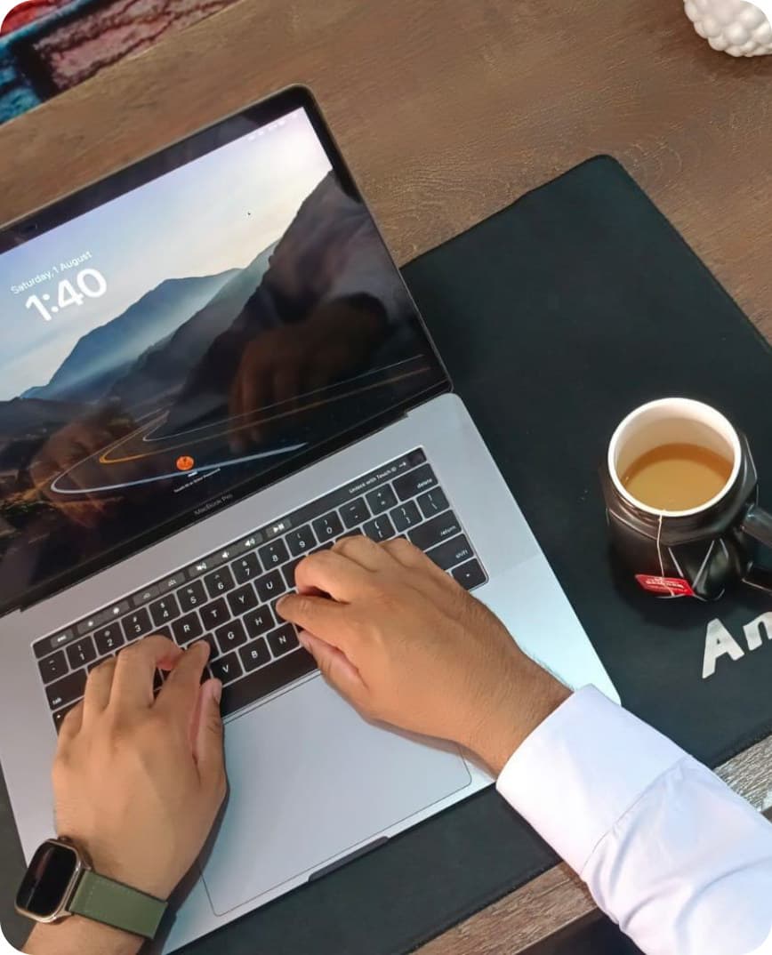 Working on a laptop at a Co-Remotely desk with a cup of tea