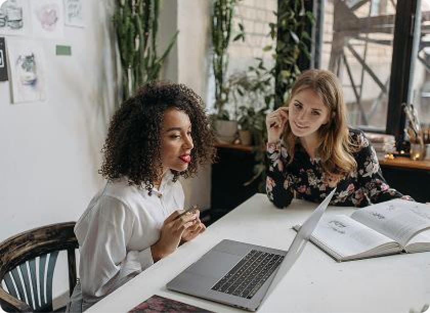 Two members collaborating over a laptop